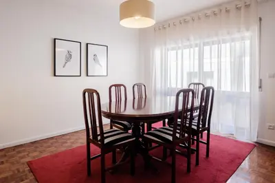 a dining room with a table and four chairs at Music House 3 bedroom Apt w garage in Porto