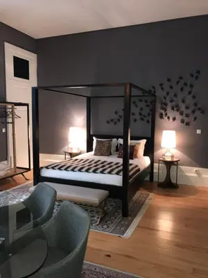 a bedroom with a canopy bed and a chair at Oporto Chic & Cozy - Flores in Porto