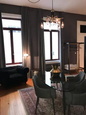a living room with a couch and chairs and a chandelier at Oporto Chic & Cozy - Flores in Porto