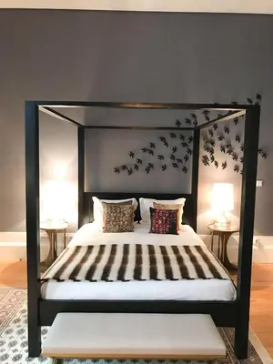 a bedroom with a canopy bed with birds on the wall at Oporto Chic & Cozy - Flores in Porto