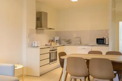 a kitchen with a table and chairs in a room at Hotel Spot Family Suites in Porto