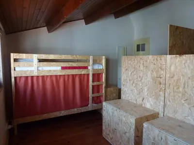 a room with two bunk beds and a red fence at Canvas Atelier Hostel in Porto