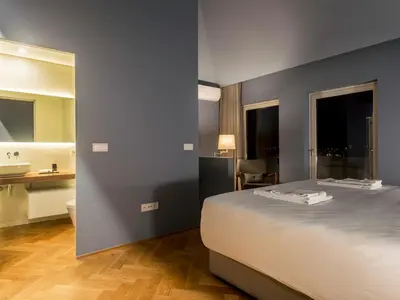 a bedroom with a large bed and a bathroom at Domum 2 in Porto
