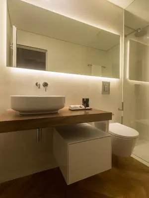 a bathroom with a sink and a toilet and a mirror at Domum 2 in Porto