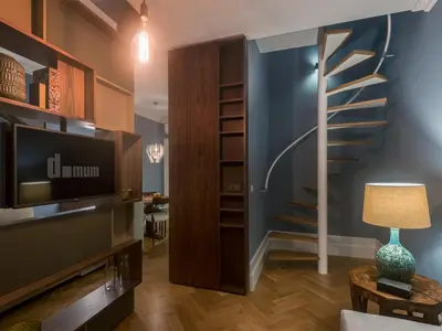 a living room with a tv and a staircase at Domum 2 in Porto