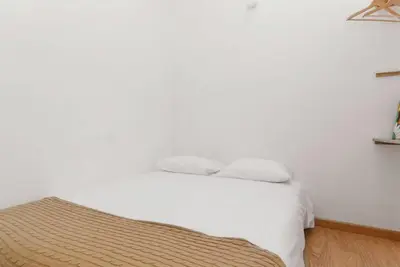 a white bed with two pillows in a bedroom at Goabio Apartment 3 Riverview in Porto