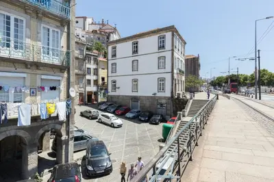 a city street with cars parked in a parking lot at Goabio Apartment 3 Riverview in Porto