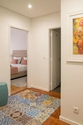 a living room with a bed and a rug at Simon Guest Apartments in Porto