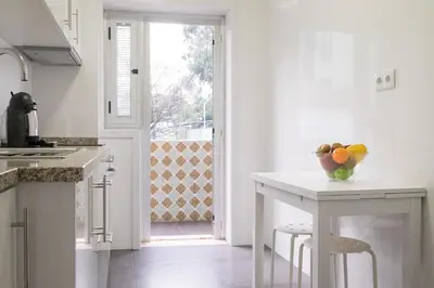 a kitchen with a table with a bowl of fruit on it at Simon Guest Apartments in Porto