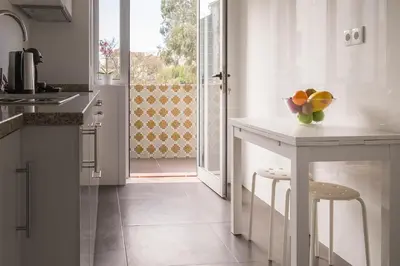 a kitchen with a counter with a bowl of fruit on it at Simon Guest Apartments in Porto