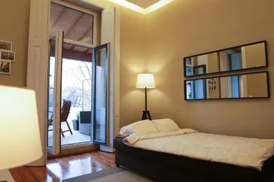 a bedroom with a bed and a mirror at daPraça Apartments in Porto