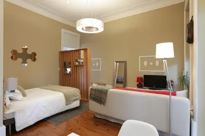 a bedroom with a bed and a television in it at daPraça Apartments in Porto