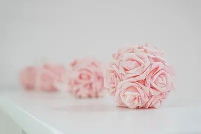 a bunch of pink roses on a white table at Oporto Downtown View Apartment in Porto
