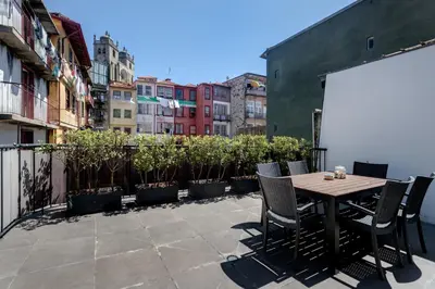 a patio with a table and chairs on a balcony at Mouzinho 244 - Porto Houses & Suites in Porto