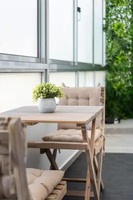 a wooden table with a potted plant on a patio at Casa das Musas in Porto