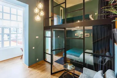 a room with a bunk bed and a couch at Abbey Apartments City Center Bolhão in Porto
