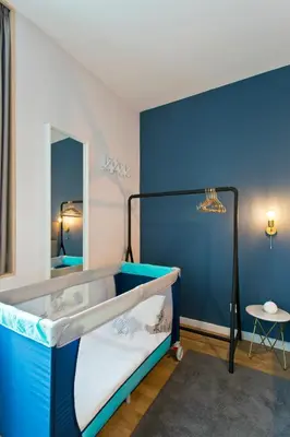 a bunk bed in a room with a blue wall at Abbey Apartments City Center Bolhão in Porto