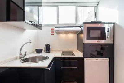 a small kitchen with a sink and a microwave at GuestReady - Pratinhas in Porto