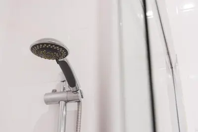 a shower head in the corner of a shower at GuestReady - Pratinhas in Porto
