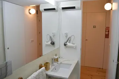 a bathroom with a sink and a mirror at Oporto Old In New in Porto