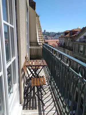 a bench sitting on the balcony of a building at H2O Porto Ribeira in Porto