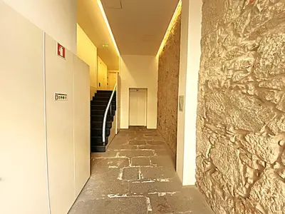 a hallway of a building with a stone wall at PORTO SWEETHEART - Almada in Porto