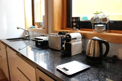 a kitchen counter with a coffee maker on it at Casa São Dinis in Porto