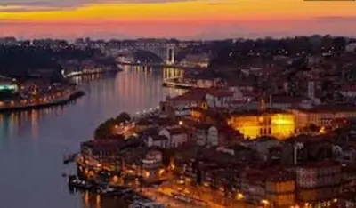 a view of a city with a river at night at vitoria flat in Porto
