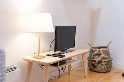 a desk with a computer monitor and a lamp on it at Loft 72 in Porto