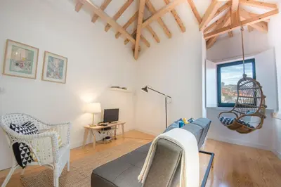 a living room with a couch and a chair at Loft 72 in Porto