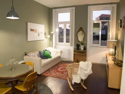 a living room with a white couch and a table at Merc Porto Central Place in Porto