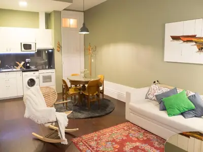 a living room with a white couch and a table at Merc Porto Central Place in Porto