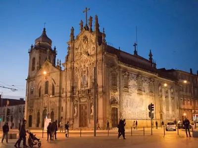 an old church with people walking in front of it at Merc Porto Central Place in Porto