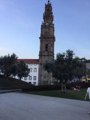 a clock tower in front of a building at Central & Charming Clérigos Appartments in Porto
