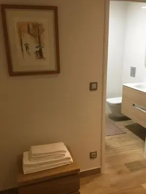 a bathroom with a sink and a table with towels at Central & Charming Clérigos Appartments in Porto
