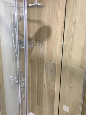 a shower with a glass door in a bathroom at Central & Charming Clérigos Appartments in Porto