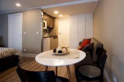a small living room with a table and a couch at Welcome to My City 