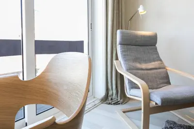a chair in a room with a window at Santa Catarina Cozy Nest - Porto Downtown in Porto