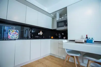 a white kitchen with white cabinets and a counter at Almada Story Apartments by Porto City Hosts in Porto