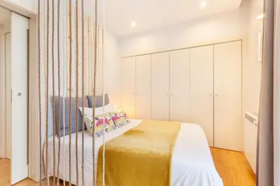 a bedroom with a bed with a curtain at D&S - Ribeira Premium Apartments in Porto
