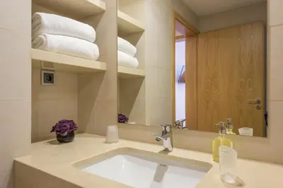 a bathroom with a sink and a mirror and towels at Almada Domus in Porto