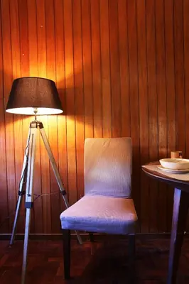 a lamp and a chair next to a table with at Studio DOWNTOWN in Porto