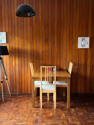 a wooden table with two chairs and a lamp at Studio DOWNTOWN in Porto