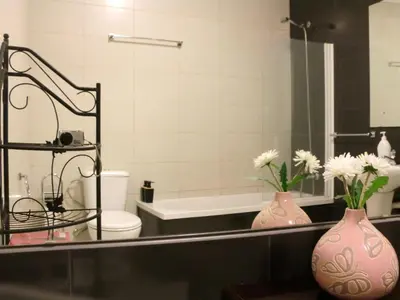 a bathroom with a sink and a toilet and a mirror at Mira Porto House in Vila Nova de Gaia