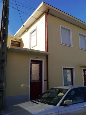 a house with a car parked in front of it at Apartamento Boavista in Vila Nova de Gaia