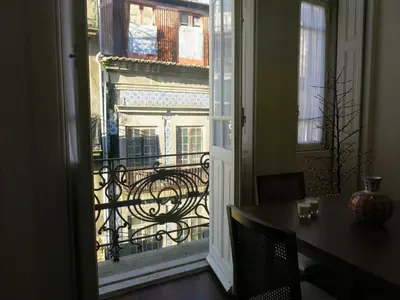 a white kitchen with white cabinets and a microwave at Chateau Flores in Porto