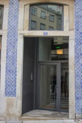 an entrance to a building with a glass door at Bright Downtown Apartment in Porto