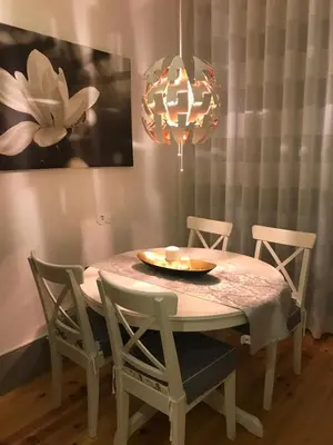a dining room table with chairs and a chandelier at Cozy Flat Porto Downtown in Porto
