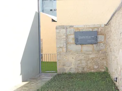 a stone wall with a sign on the side of a building at Cozy Flat Porto Downtown in Porto