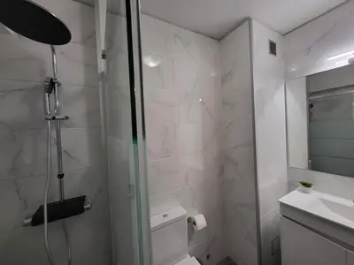 a bathroom with a shower and a toilet and a sink at Vale Formoso Apartment in Porto
